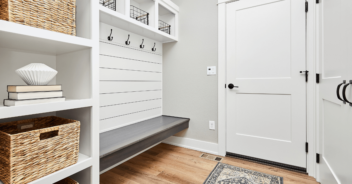 A white entryway with built-in bench.