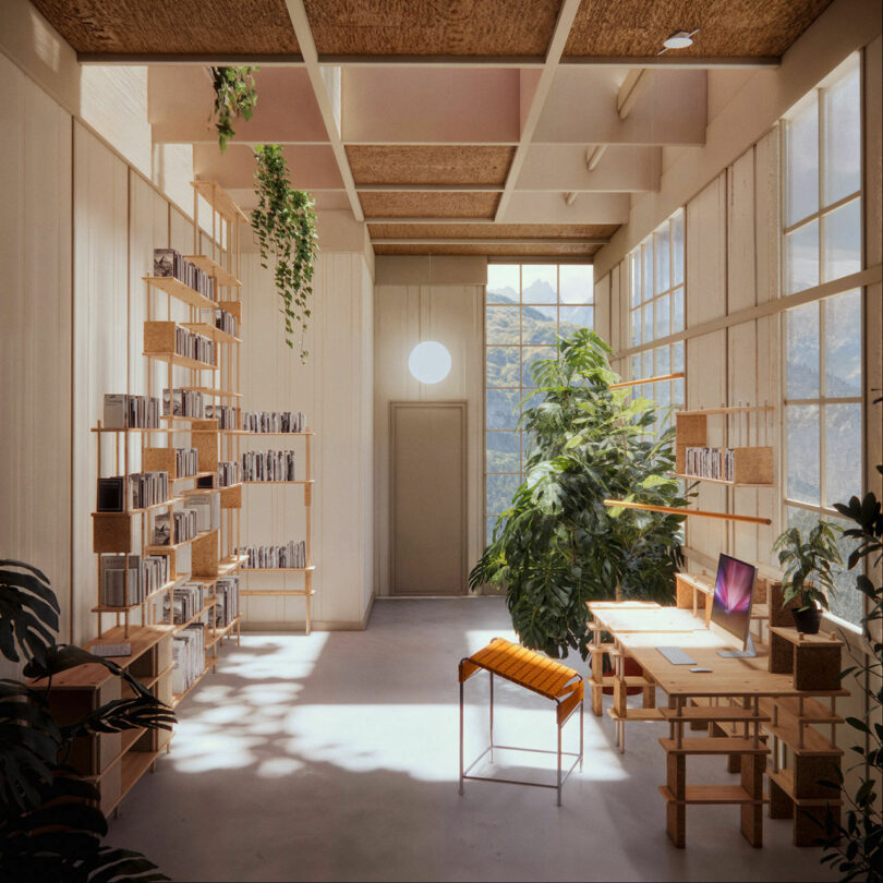 A bright room with large windows, wooden shelves filled with books, a desk with a computer, and several potted plants