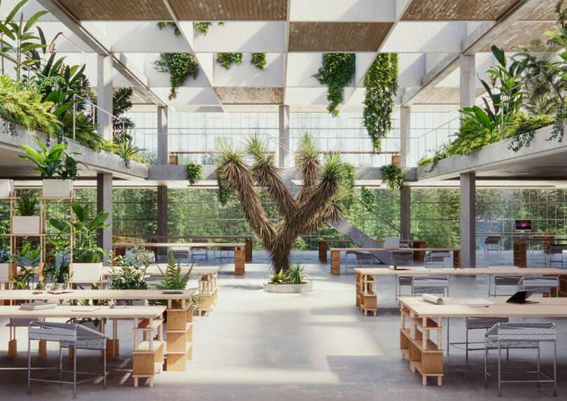 Modern open-plan office with large windows, abundant greenery, wooden desks, and chairs. Central sculpture made of palm leaves and plants. Bright, airy atmosphere