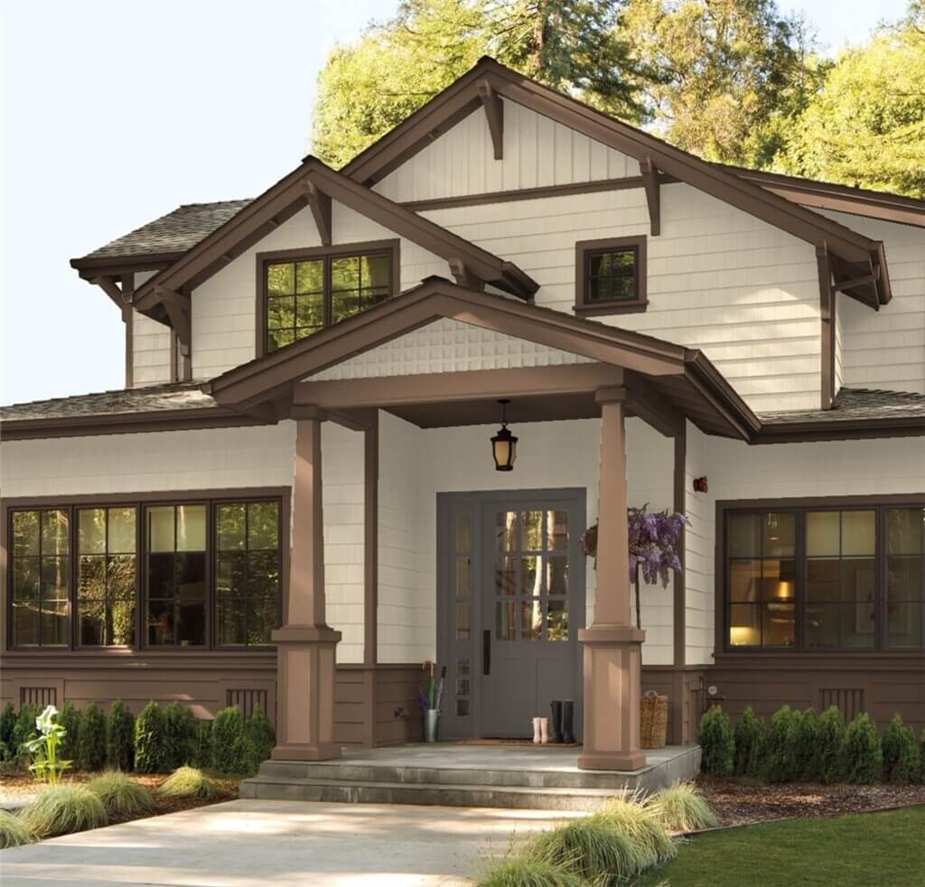 A family home with off-white siding and brown trim.