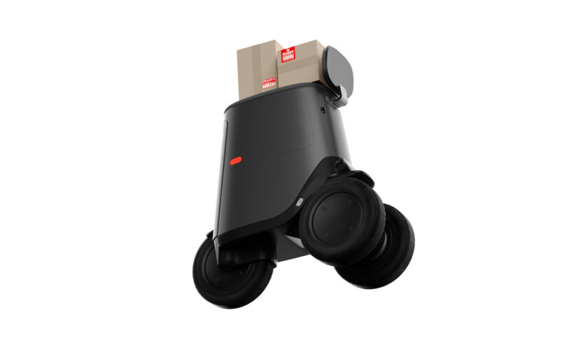 A black wheeled robot with red details carries packages labeled 