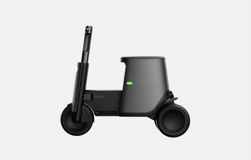 Side view of a black, minimalist, three-wheeled electric scooter with a storage compartment on a white background