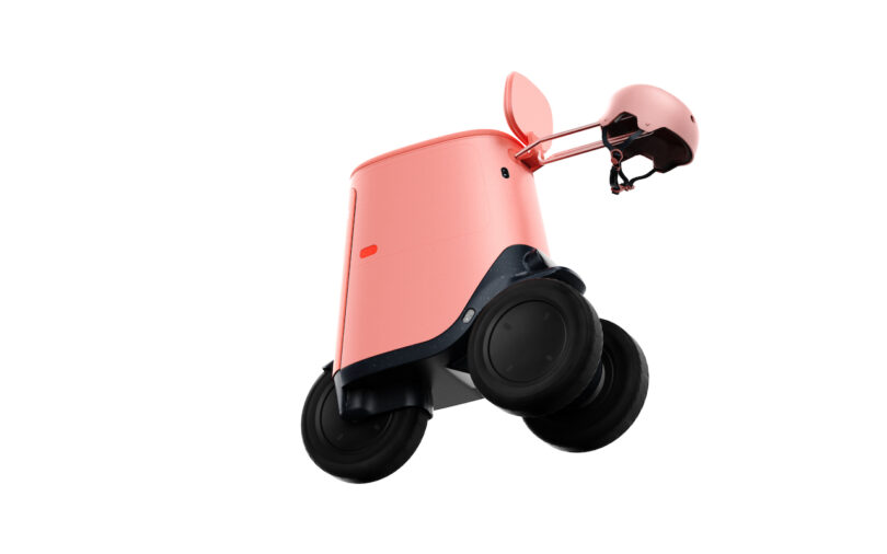 A pink, two-wheeled robot with a lifted compartment lid and a small helmet attached to its side