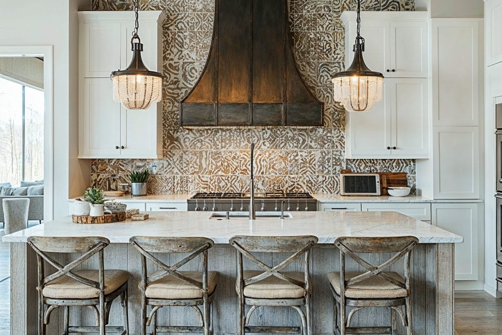 Statement pendant lights over an island in a kitchen by Decorilla