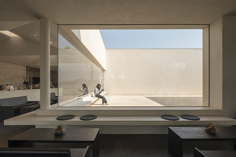 funnel-shaped openings bring light within songmont retail space by archstudio in beijing