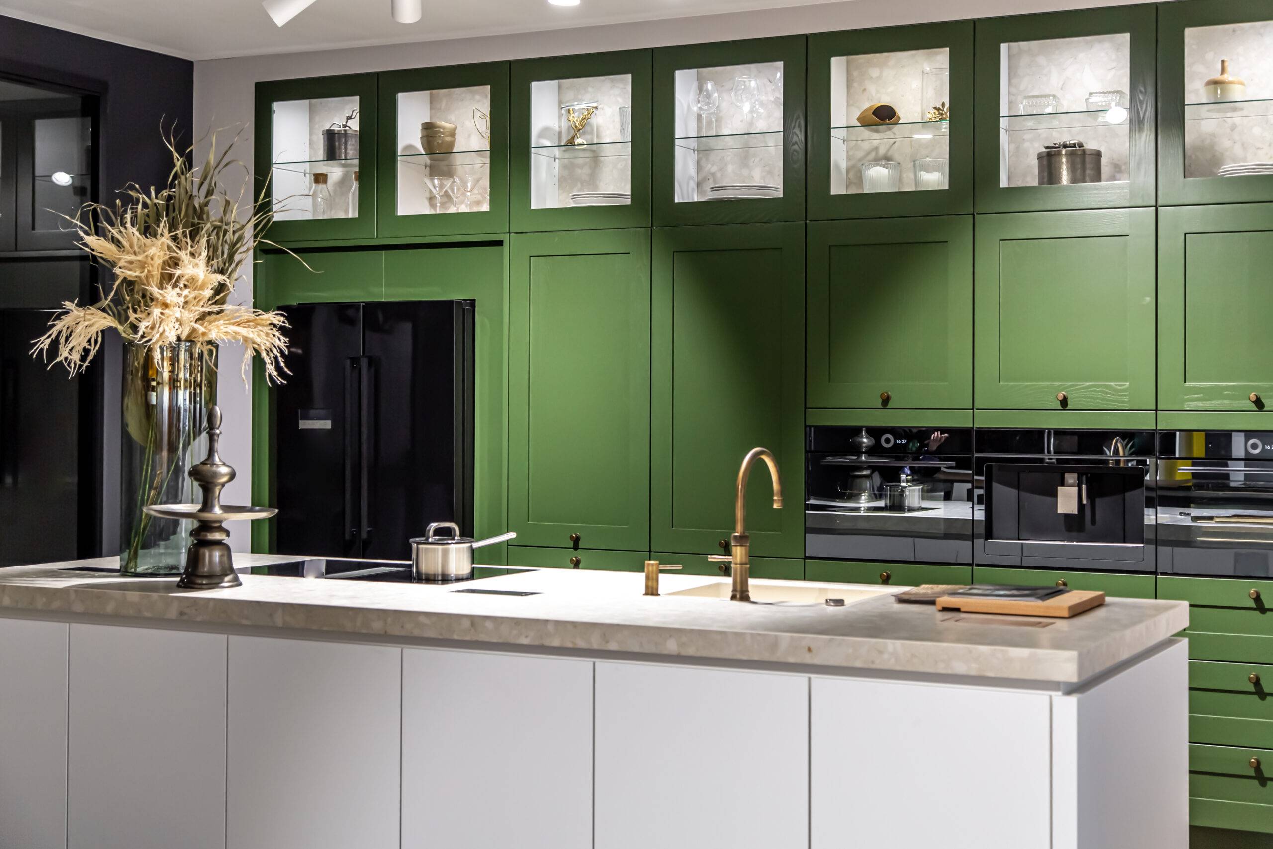 Modern kitchen interior with green cabinet and white countertop, design and decoration.