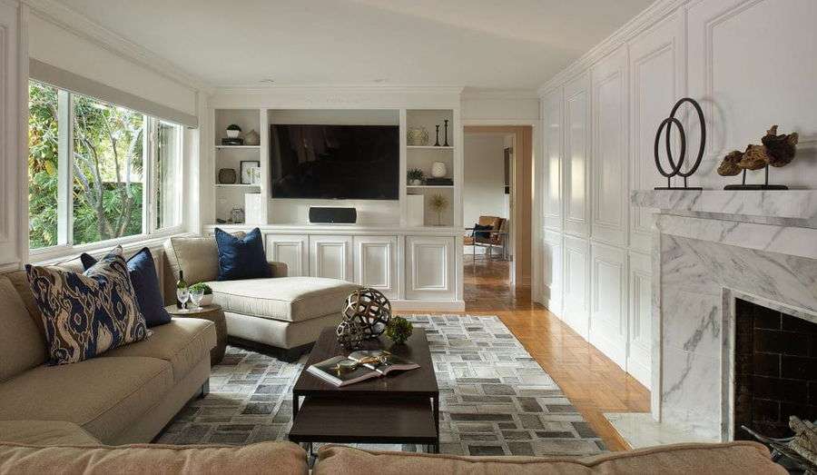 Transitional living room decor around a TV by Decorilla designer, Stella P. 