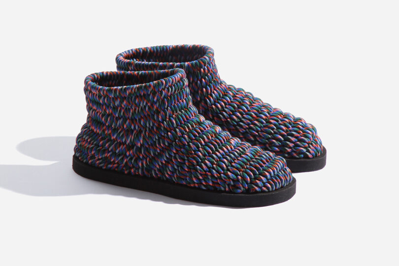 Colorful woven ankle-high shoes with a textured pattern, featuring a black sole, set against a plain light background.