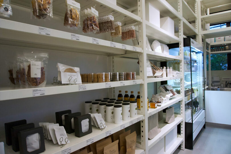 Shelves stocked with various packaged goods, bottles, and containers in a well-lit, organized store interior at TRUNK(HOTEL) CAT STREET
