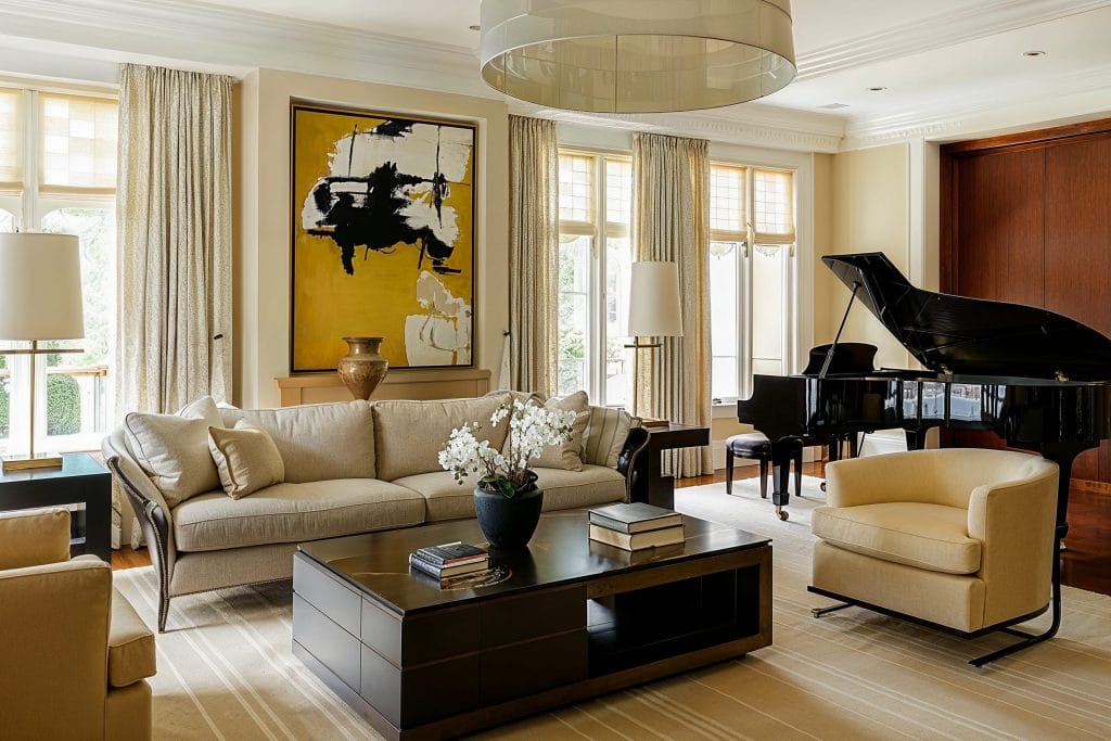 Gentle yellow paints that improve home value in a contemporary living room by Decorilla