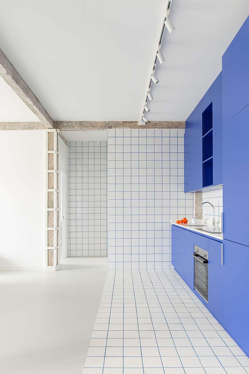 blue and white interiors link renovated 1930s apartment to its seaside setting in spain