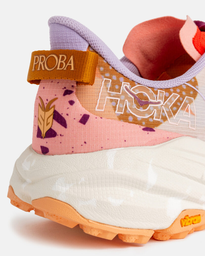 Close-up of the heel of a HOKA running shoe with a colorful design,