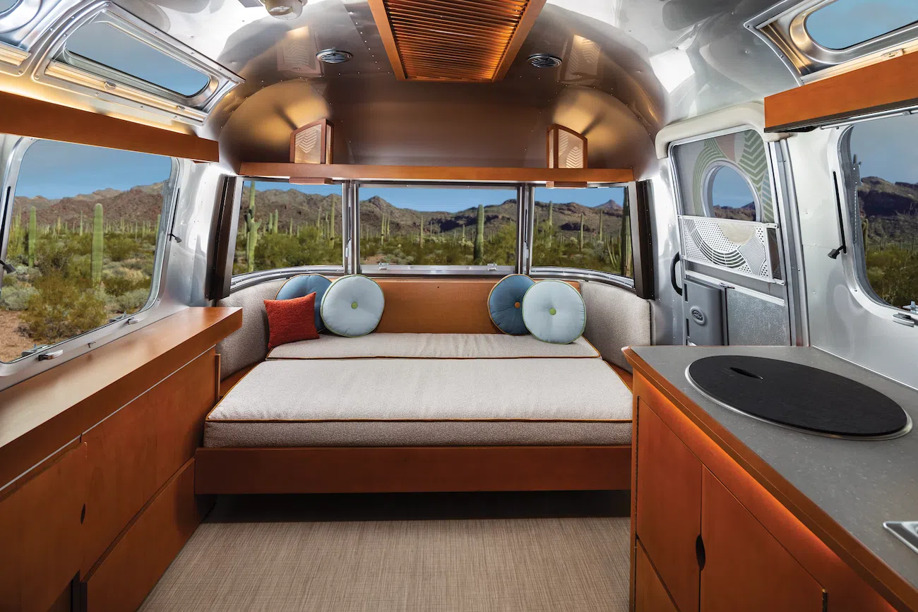 Living space converted into additional sleeping space in Frank Lloyd Wright Usonian Travel Trailer with Airstream