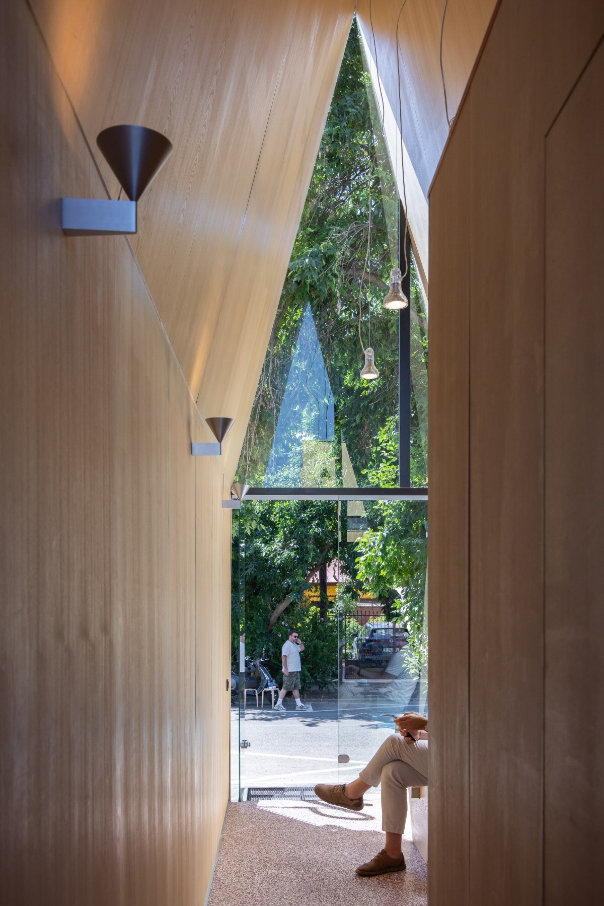 vinklu inserts triangular prism into narrow urban gap for coffee shop in romania