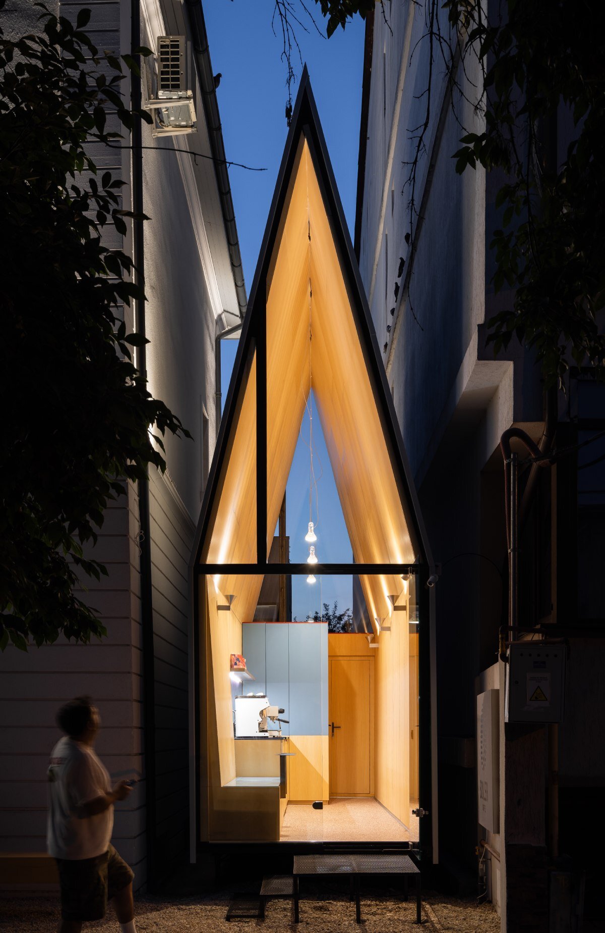 vinklu inserts triangular prism into narrow urban gap for coffee shop in romania