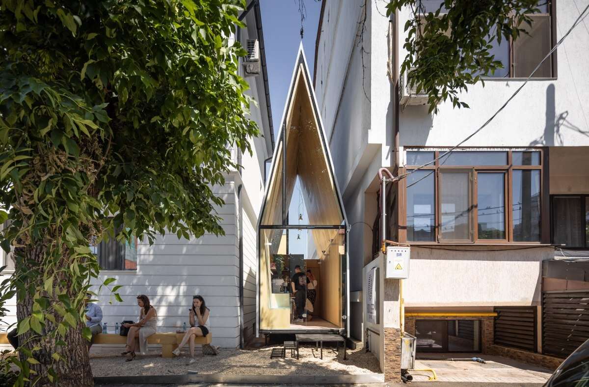 vinklu inserts triangular prism into narrow urban gap for coffee shop in romania
