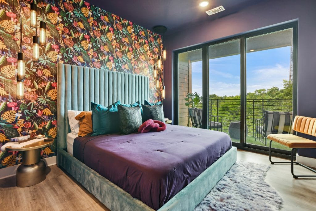 Nature-inspired wallpaper and decor in a bedroom by Decorilla designer, Marve M.