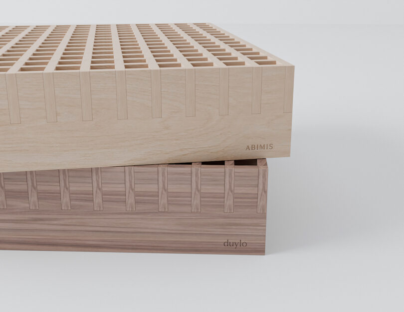 Two wooden blocks with interlocking dovetail joints, one light-colored labeled 