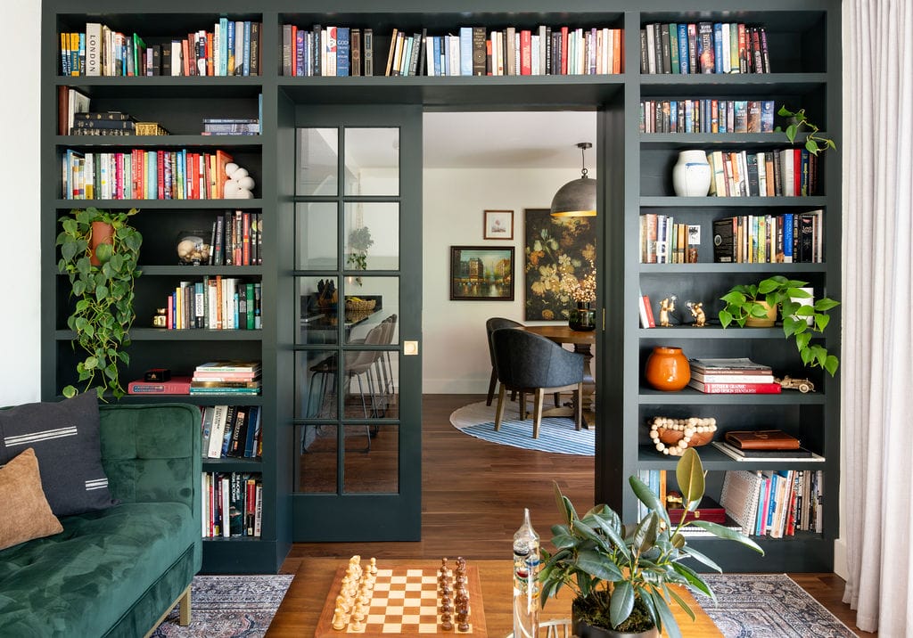 Eclectic home library featuring intentional clutter by DECORILLA designer, Sadi M.