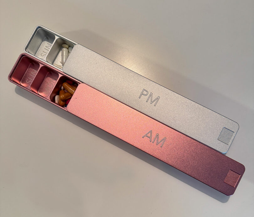 Two pill organizers labeled 