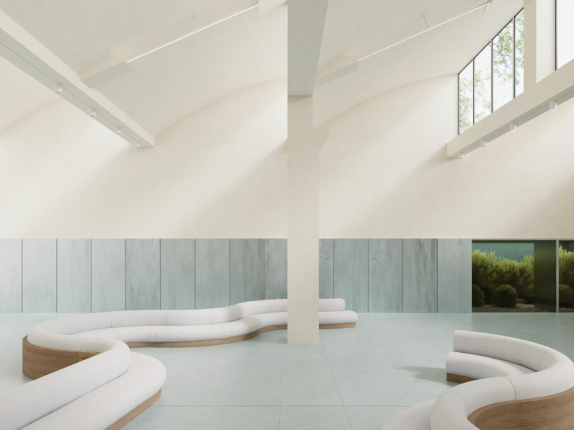 Spacious, modern interior with curved white sofas, high ceilings, large windows, and minimalist decor; hints of candy-colored accents complement the lush greenery visible outside.
