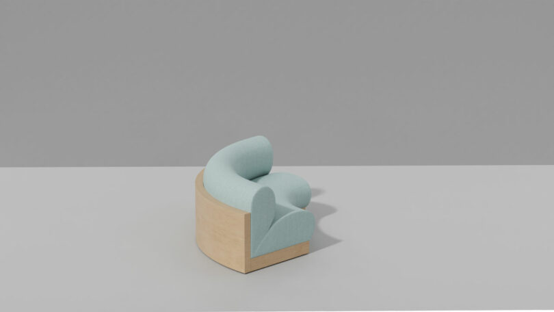 A light blue, candy-colored curved upholstered chair with a wooden base sits on a plain grey surface against a grey background.