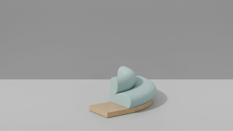 A minimalist light blue curved sofa with a wooden base, reminiscent of soft candy hues, placed against a plain gray background.