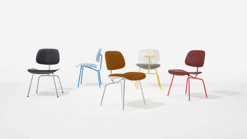 Five modern chairs with different colored seats and legs are arranged on a white background.