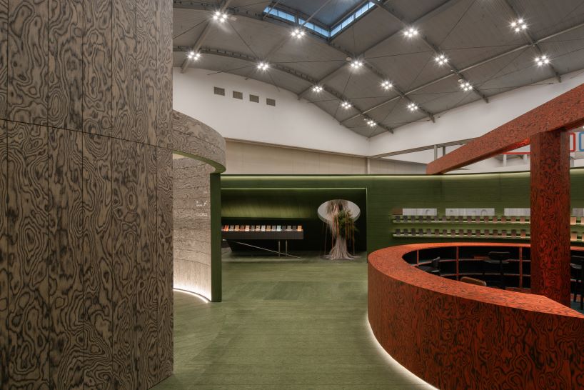 circular timber pavilion with voids and slits displays variety of veneer textures and finishes