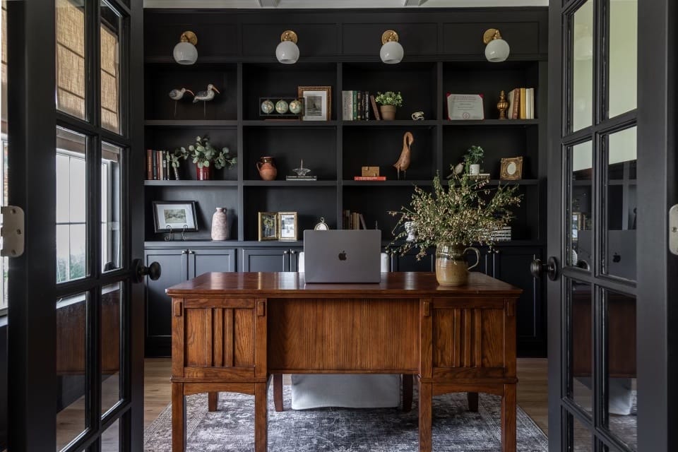 Elegant study area with vintage desk capturing the essence of dark academia style, by Decorilla designer Julissa R