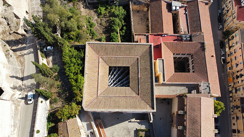 translucent organza curtains float within renaissance arched courtyard in spain