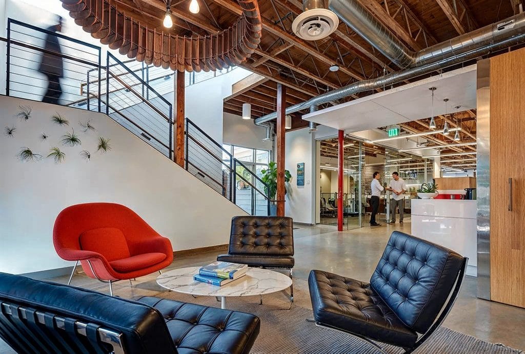 Industrial decor in a modern workplace by Decorilla designer, Lara S.