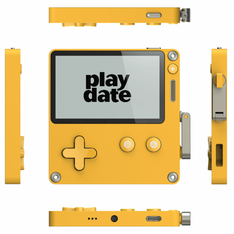 A yellow handheld gaming device with a crank on the side, labeled