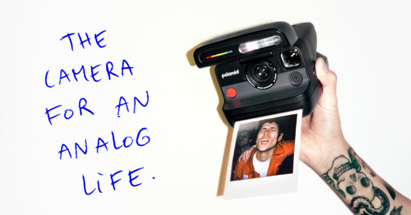 A tattooed hand holds a Polaroid camera printing a photo of a smiling person; handwritten text reads,