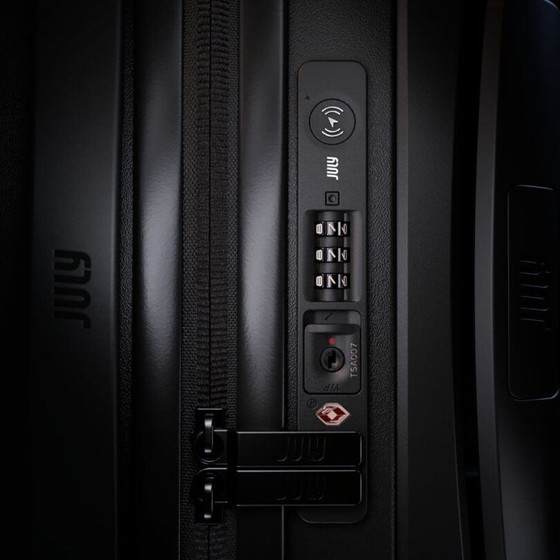 Close-up of a black suitcase featuring a zipper lock, combination dial, and TSA keyhole, with the brand name 