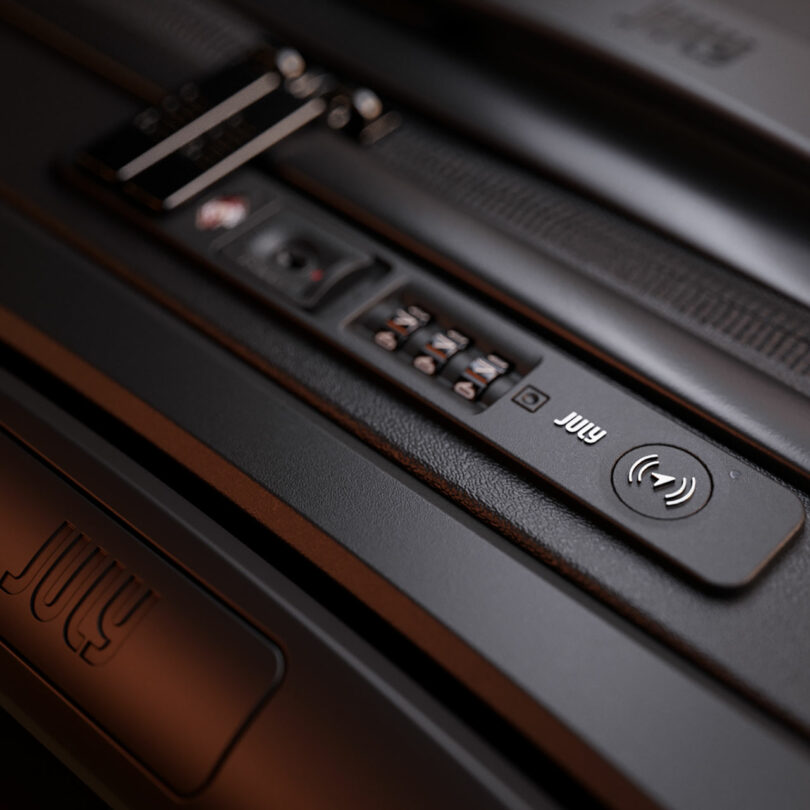 Close-up of a suitcase lock mechanism with a numeric combination lock and the brand name 