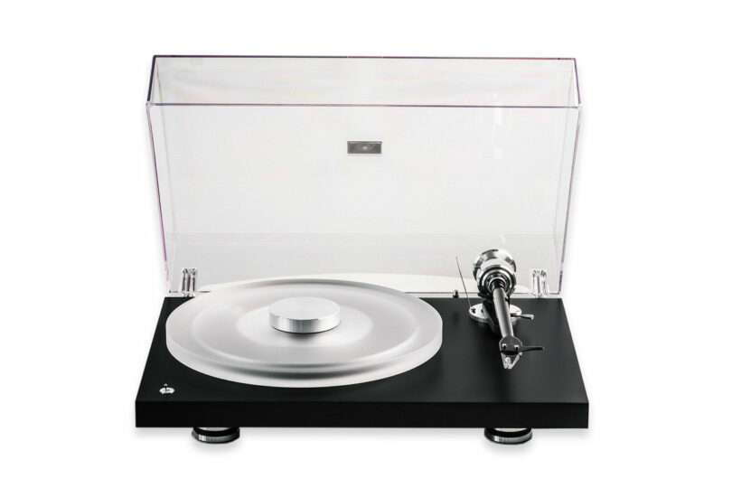 A modern turntable with a transparent dust cover, a silver platter, and a black base, viewed from the front against a white background.