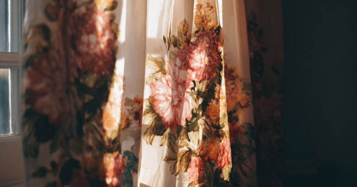 Cinematic shot of a floral curtain in a well-lit home.
