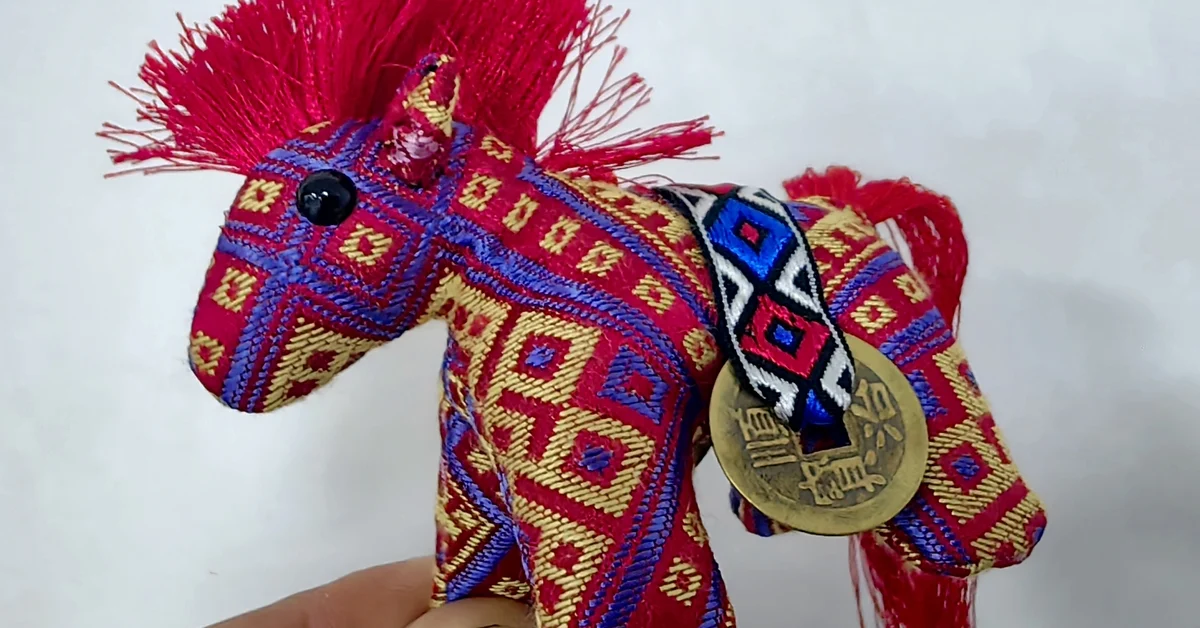 Handmade Year of the Horse zodiac ornament photographed at the workshop of Zhuangjin Intangible Cultural Heritage Inheritance Center in Xincheng County, Laibin City, Guangxi, China on December 23, 2025.