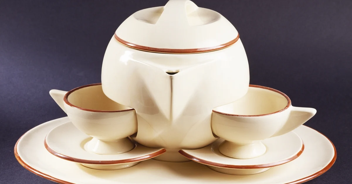 FRANCE - SEPTEMBER 19: Tea service for two in cream with brown edges, ceramic.
