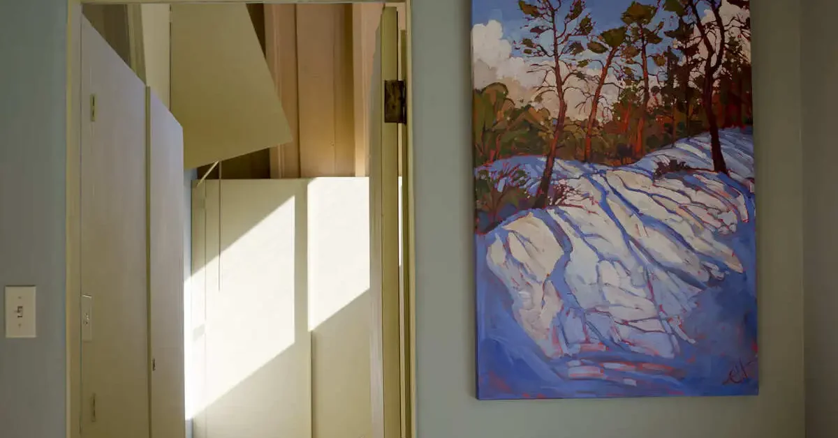 Unframed art used by a doorway.