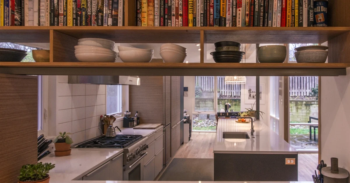A view through the new entryway using books and display shelves into the kitchen of Gabriela Sakamota and Tim Vermeulen's remodeled mid century house on November, 19, 2015 in Takoma Park, MD.
