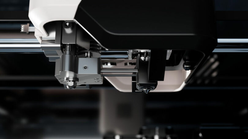 Close-up view of a 3D printer extruder head in operation, with mechanical components and precision parts highlighted as the FibreSeeker technology ensures optimal printing performance.