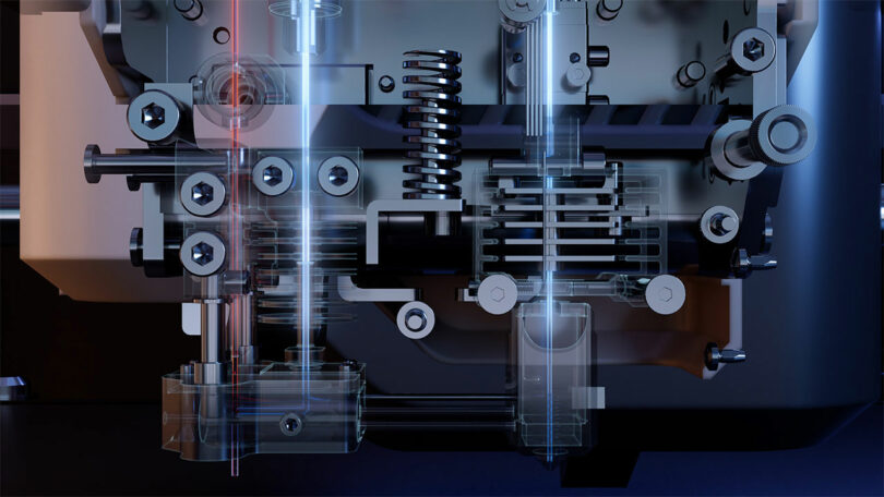 Close-up view of a mechanical assembly with metal springs, screws, and gears, featuring FibreSeeker components and transparent sections for detailed technical visualization of internal mechanisms.
