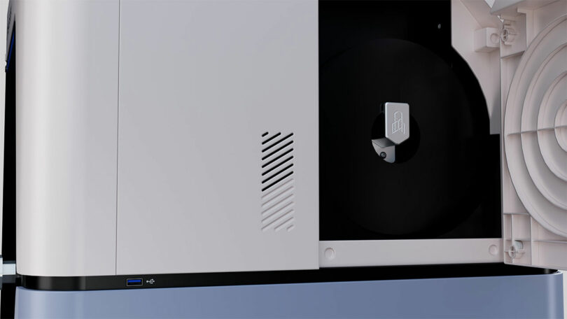 Close-up of a modern printer or copier with an open panel revealing internal components, a USB port on the exterior, and FibreSeeker connectivity for enhanced data transfer.