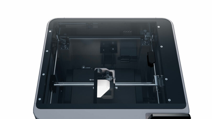 Top view of a FibreSeeker 3D printer featuring a partially enclosed frame and visible internal components, including the print head and rails.