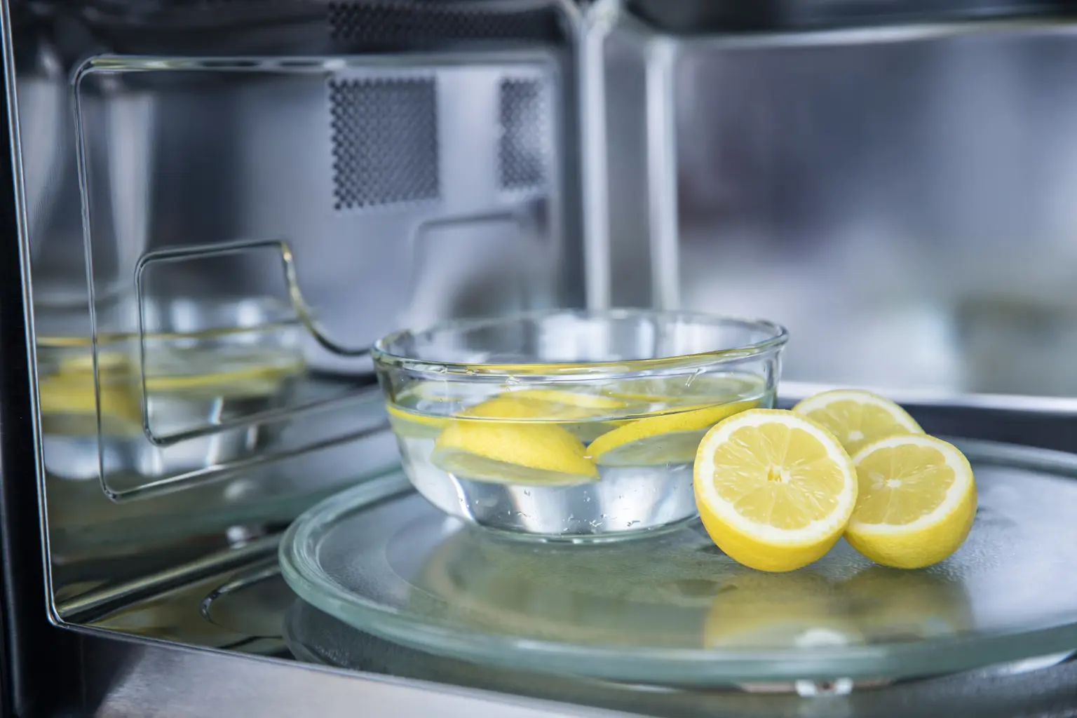 A bowl of water and lemon slices kept inside an oven to help kill odor and keep it fresh