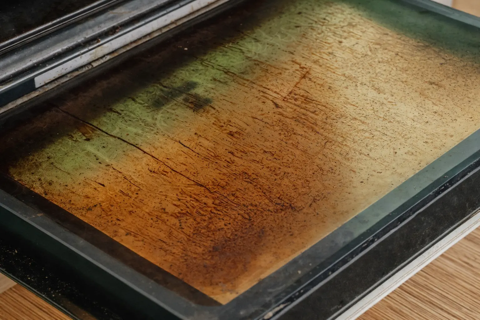 An image of a dirty oven glass door.