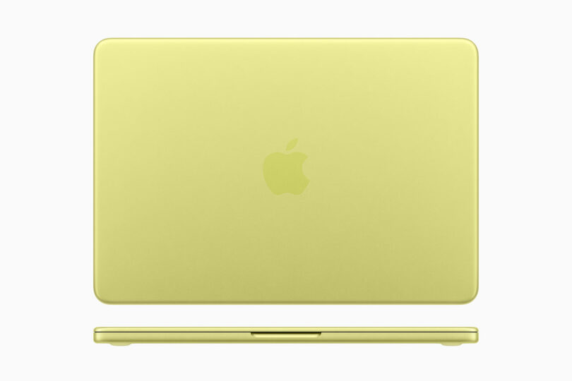 A closed, yellow Apple laptop viewed from above with the iconic Apple logo centered on the lid, displayed against a plain white background.