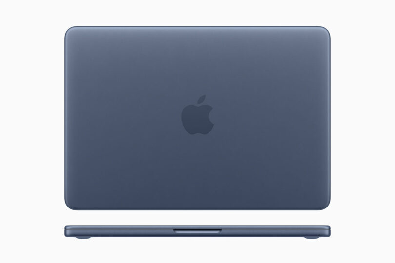 A closed, blue Apple MacBook laptop is shown from the back and front against a plain, light background, highlighting its iconic Apple design.